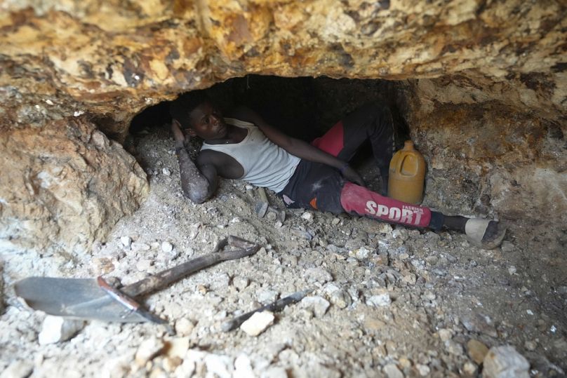 A worker takes a rest at an illegal lithium mining site in Paseli, north central Nigeria, Tuesday, Nov 5, 2024. (AP Photo/Sunday Alamba)