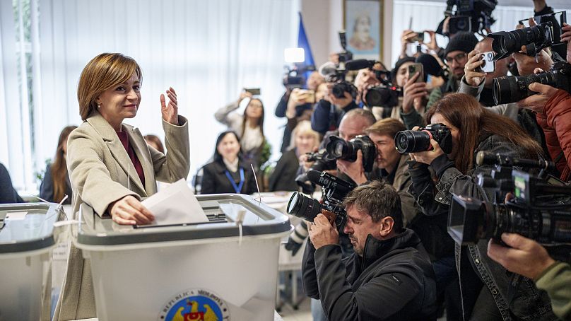 Moldova's President Maia Sandu prepares to cast her vote, in Chisinau, Moldova, Sunday, Oct. 20, 2024, during a presidential election and a referendum on EU membership.