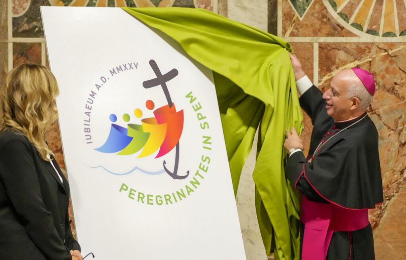 Mgr Rino Fisichella, à droite, Pro-préfet du Dicastère pour l'évangélisation, dévoile le logo officiel du Jubilé catholique 2025 lors d'une conférence de presse au Vatican, ma