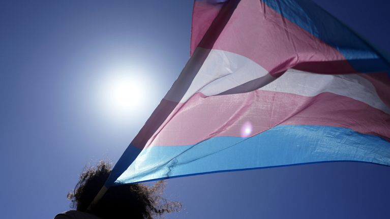 An attendee carries a transgender flag during a march in Portugal in March 2024.