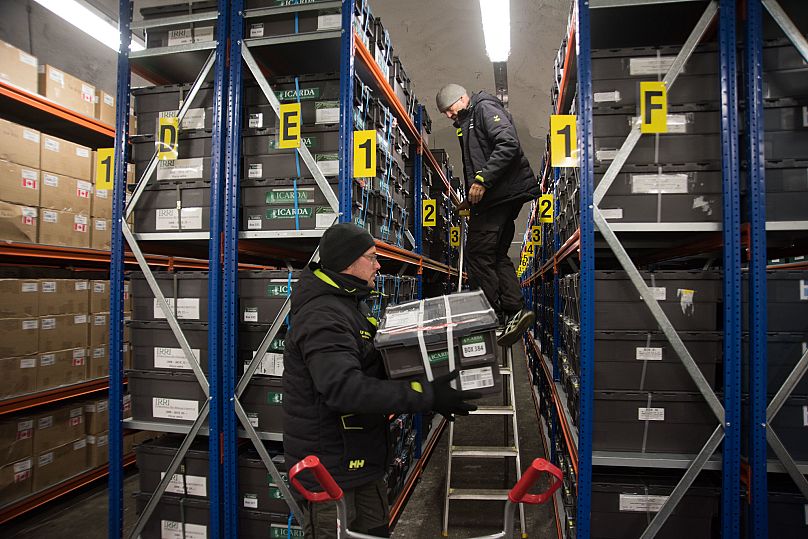 NordGen staff, Fredrik Kollberg (left) and Åsmund Asdal bring new seed boxes in to final position in the Vault shelves
