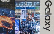 Visitors walk through the Mobile World Congress 2024 in Barcelona, Spain, Monday, Feb. 26, 2024