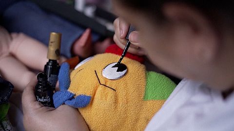 volunteer repairing a soft toy, Toy Hospital, Carracas, Venezuela, 05.12.2024