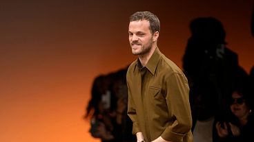 Matthieu Blazy accepts applause after the conclusion of the Bottega Veneta women's Fall-Winter 2024-25 collection presented in Milan, Italy, Feb. 24, 2024.