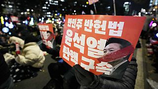 Protesters hold banners during a rally to demand South Korean President Yoon Suk Yeol's impeachment outside the National Assembly in Seoul, South Korea, Friday, Dec. 13, 2024