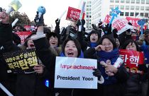 Participants react after hearing the news that South Korea's parliament voted to impeach President Yoon Suk Yeol outside the National Assembly in Seoul