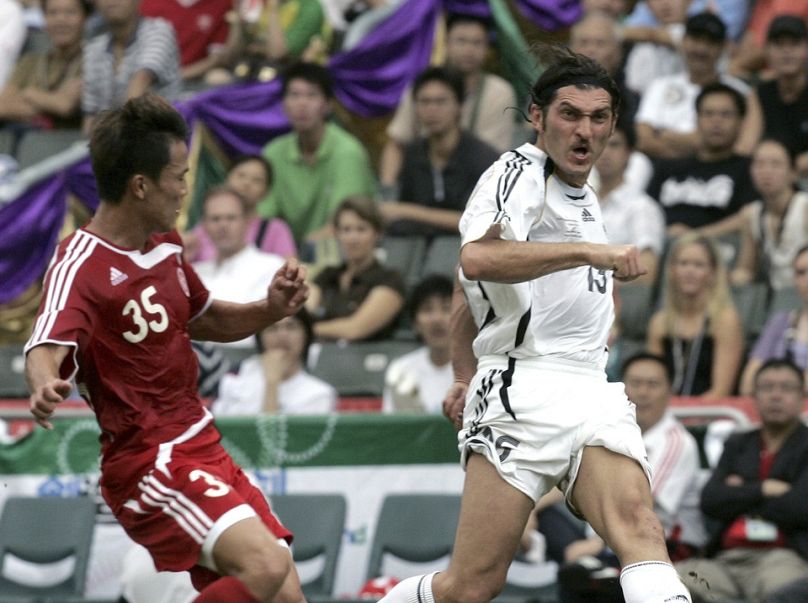  Mikheil Kavelashvili, right, shoots towards goal during the Reunification Cup against Chinese national team in Hong Kong, on July 1, 2007.