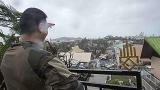 A soldier observes the damage on the French territory of Mayotte in the Indian Ocean, following the passage of cyclone Chido, in Mayotte on 15.12.2024