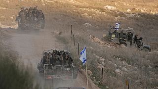 Israeli soldiers cross the security fence moving towards the so-called Alpha Line that separates the Israeli-annexed Golan Heights from Syria, in the town of Majdal Shams.
