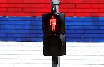 File photo: A wall that shows the colours of the Serbian flag behind traffic light in Belgrade, Serbia, Tuesday, May 18, 2021.