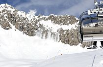 The slope patrol in a helicopter of Air Zermatt is throwing explosive material out of the window to artificially blow up avalanches this noon at the skiing resort Belalp, 2018