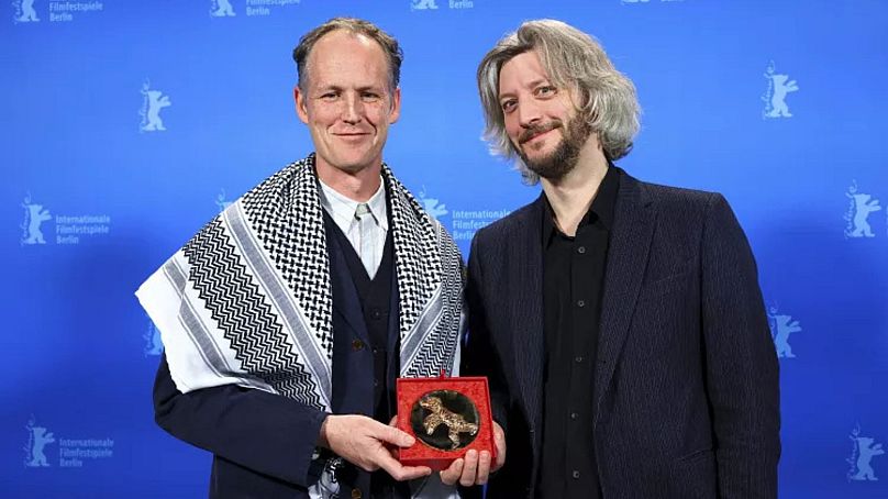 Guillaume Cailleau and Ben Russell pose with the Encounters Best Film Award for 'Direct Action'