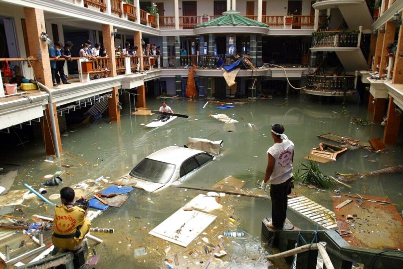 Rescue and clean-up crew survey a flooded lobby at the Seapearl Beach Hotel along Patong Beach on Phuket Island, Thailand on 28 December 2004. 