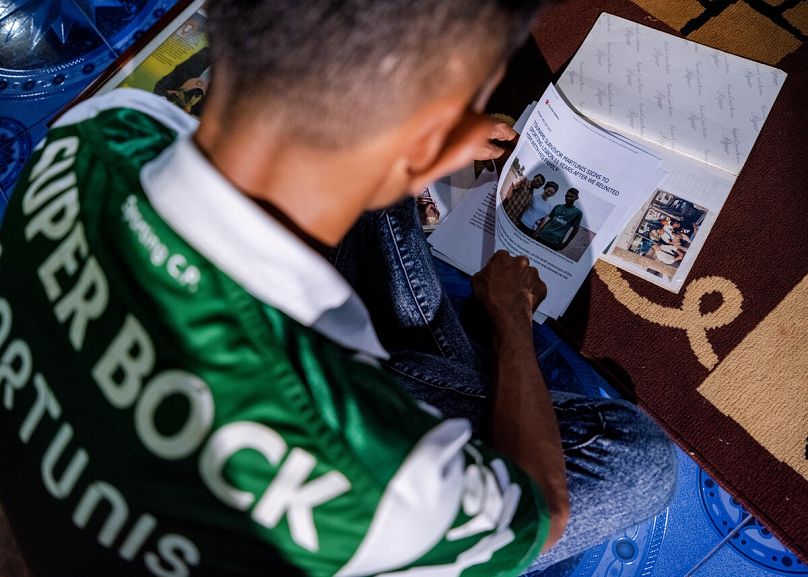 Martunis, 27, looks at news about himself at his home in Aceh, Indonesia. 