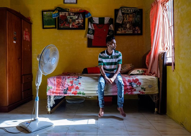 Martunis, 27, sits on his bed at his house in Aceh, Indonesia. 