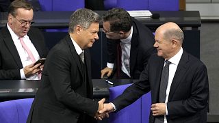 German Chancellor Olaf Scholz, right, shakes hand with Economy and Climate Minister Robert Habeck after losing a vote of confidence in parliament 