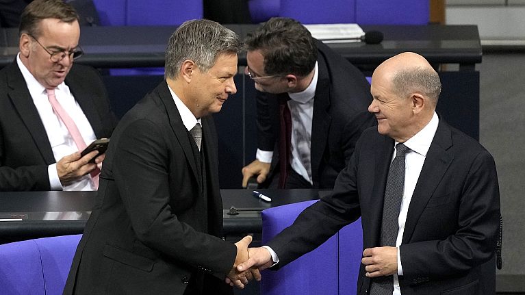 German Chancellor Olaf Scholz, right, shakes hand with Economy and Climate Minister Robert Habeck after losing a vote of confidence in parliament 