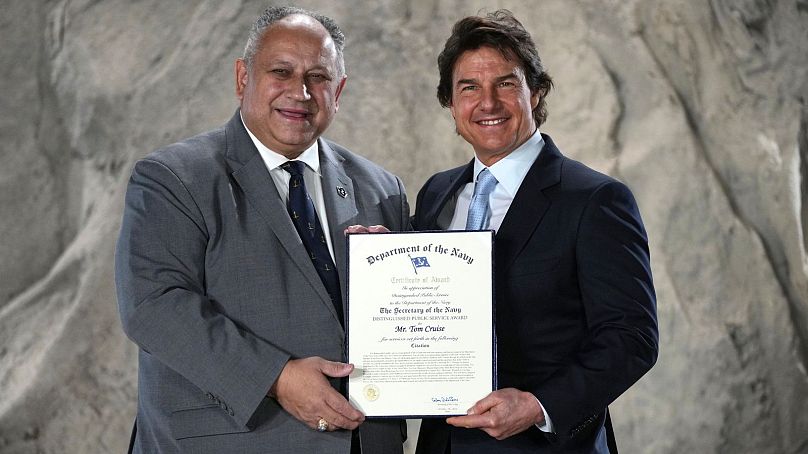 Tom Cruise, right, receives a Navy Distinguished Public Service Award from The United States Secretary of the Navy Carlos Del Toro - 17 Dec. 2024