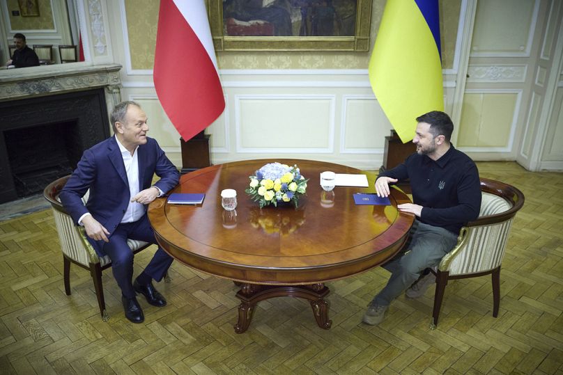 Ukrainian President Volodymyr Zelenskyy, right, and Polish Prime Minister Donald Tusk talk in Lviv, Ukraine, Tuesday, Dec. 17, 2024