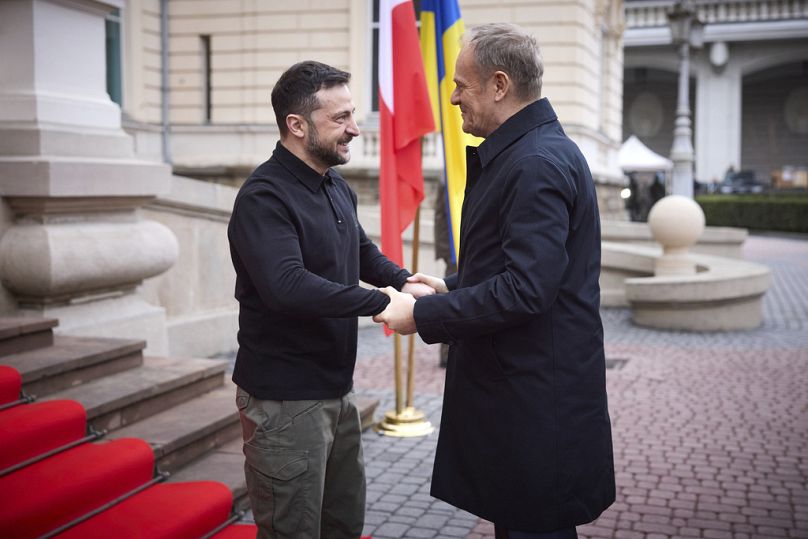 Ukrainian President Volodymyr Zelenskyy, left, shakes hands with Polish Prime Minister Donald Tusk in Lviv, Ukraine, Tuesday, Dec. 17, 2024