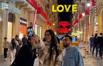 Young people taking a photo in front of the illuminations with messages of hope, Beirut, Lebanon, 17.12.2024