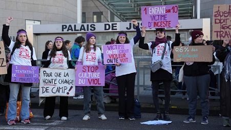 Activists hold posters in front of the Palace of Justice during a women's rights demonstration on Dec. 14, 2024, in Avignon, southern France.