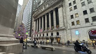 A scooter passes the New York Stock Exchange in New York's Financial District on Tuesday, Dec. 17, 2024.