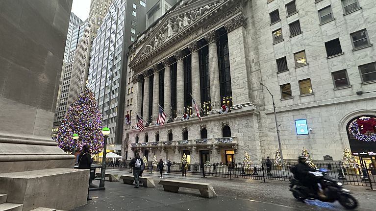 A scooter passes the New York Stock Exchange in New York's Financial District on Tuesday, Dec. 17, 2024.