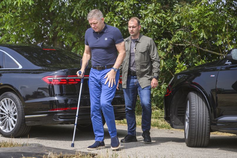 FILE: Slovak Prime Minister Robert Fico using a crutch, arrives to attend a press conference during harvest in the village of Slovenska Nova Ves, Slovakia, Monday, July 8 2024