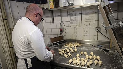 French baker Arnaud Delmontel bakes butter croissants and pains au chocolat in his bakery in Paris