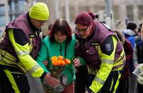 Citizens place flowers outside St. John's Church near a Christmas Market, where a car drove into a crowd on Friday evening, in Magdeburg, Germany, Saturday, Dec. 21, 2024.
