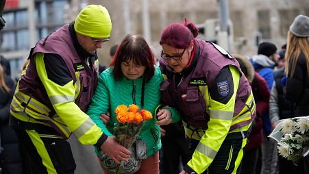 Citizens place flowers outside St. John's Church near a Christmas Market, where a car drove into a crowd on Friday evening, in Magdeburg, Germany, Saturday, Dec. 21, 2024.