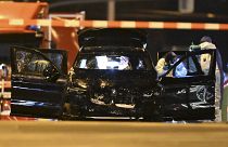 Forensics work on a damaged car sitting with its doors open after it drove into a busy Christmas market in Magdeburg, 21 December, 2024