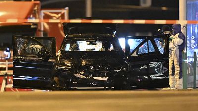 Forensics work on a damaged car after a driver ploughed into a busy Christmas market in Magdeburg, 21 December, 2024