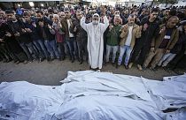 Palestinesi pregano sui corpi delle vittime di un attacco israeliano contro un'abitazione, sabato scorso, prima del funerale all'esterno dell'Ospedale dei Martiri di Al-Aqsa a Deir al-Balah, 22 dicembre 2024.