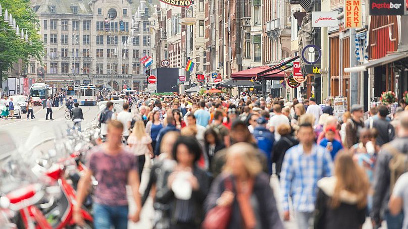 Amsterdam's Damrak Road is crowded with tourists