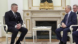 Russian President Vladimir Putin, right, and Slovak Prime Minister Robert Fico talk to each other during their meeting at the Kremlin in Moscow, Russia, Sunday, Dec. 22, 2024.