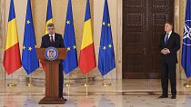 Prime Minister designate Marcel Ciolacu, left, speaks after Romanian President Klaus Iohannis, right, nominated him to form the new government in Bucharest, 23 December 2024