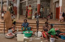 Women wash clothes after a short rain filled their pots with water, at the Lycée des Lumières where they found shelter after losing their homes, in Mamoudzou, Mayotte, Dec. 19