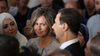 FILE PHOTO - Syria's first lady Asma Assad, left, listens to her husband Syrian President Bashar Assad as he speaks to the media in Douma, Syria, May 26, 2021.