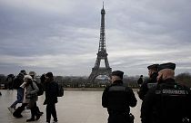 French gendarmes patrol the Trocadero plaza near the Eiffel Tower, 3 December 2023
