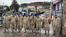 Turkish security forces stand guard next to parked ambulances at the entrance of an armament factory following an explosion in Balikesir, 24 December 2024