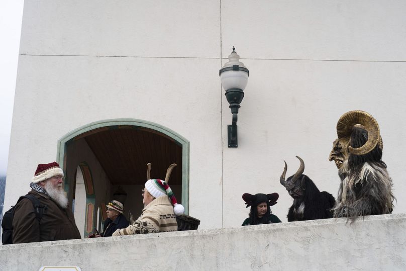 Members of the Krampus Seattle and Krampus Bremerton groups gather before walking down Front Street as part of a Krampuslauf Leavenworth event