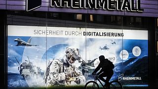 A man on a bicycle passes the headquarters of Germany's biggest arms manufacturer Rheinmetall AG in Duesseldorf, Germany