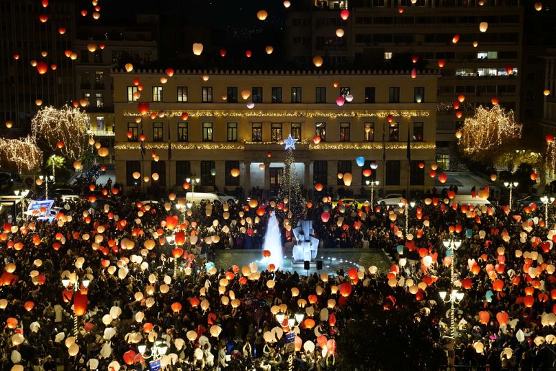 People release sky lanterns during the event entitled "The night of wishes" organized by Athens Municipality at Kotzia square on Christmas Eve, Tuesday, Dec. 24, 2024