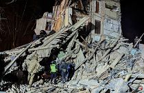 Firefighters work on a site of an apartment building destroyed by a Russian attack in Kryvyi Rih, 25 December 2024