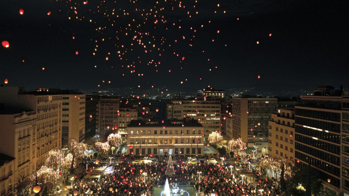 Athenians and tourists gather in Athens to release Christmas wishes on paper lanterns