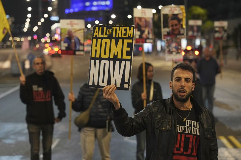 FILE - Israeli protesters outside the Ministry of Defense headquarters in Tel Aviv, Israel, call for Hamas to release hostages on Tuesday, Dec. 17, 2024. 