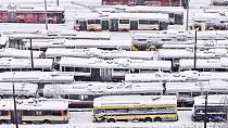 An aerial view of parked trolley buses during heavy snowfall in Sarajevo, Bosnia, Tuesday, Dec. 24, 2024