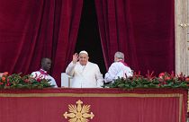 Pope Francis waves before delivering the Urbi et Orbi (Latin for 'to the city and to the world' ) Christmas' day blessing from the main balcony of St. Peter's Basilica at the 